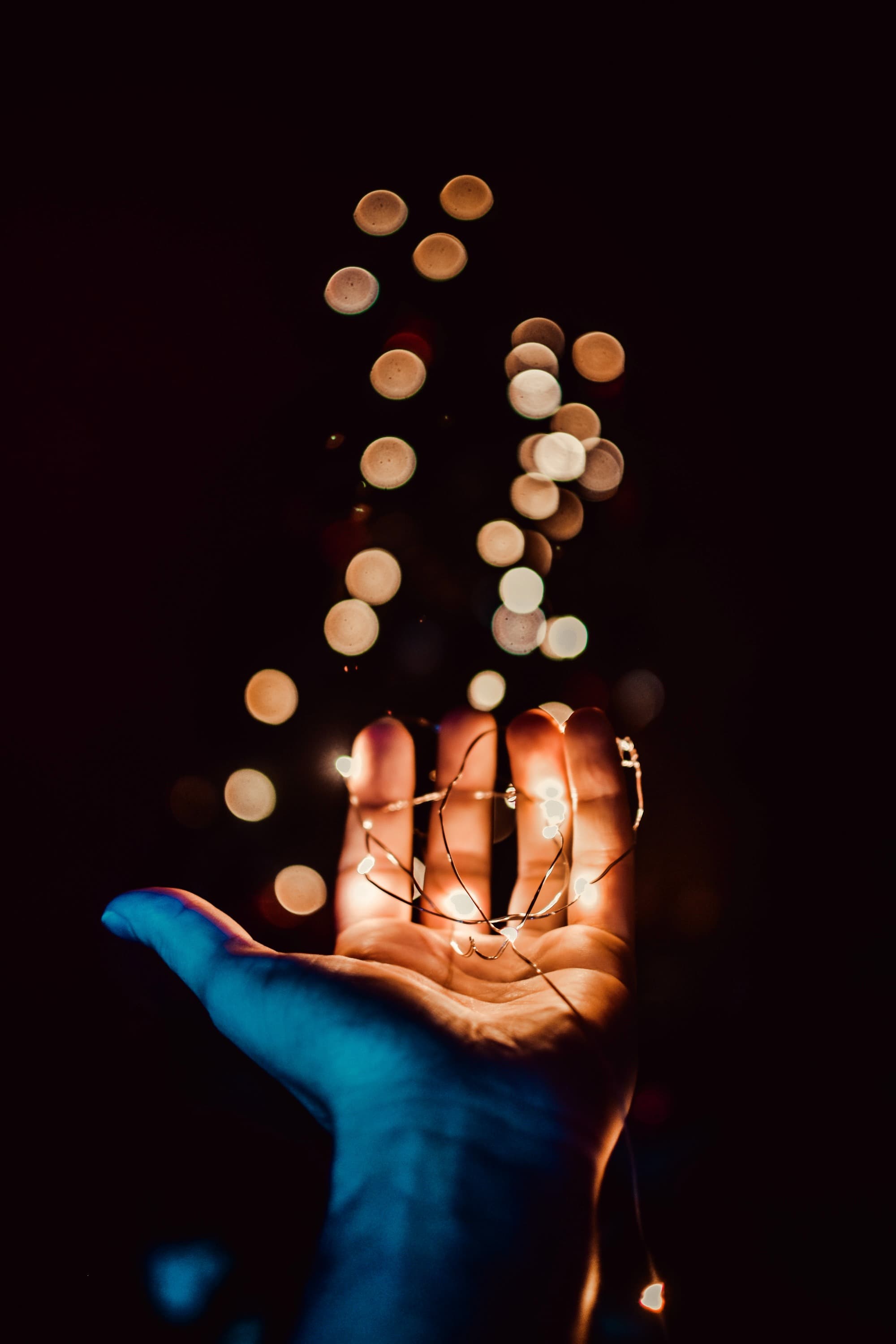 Hand holding lights with bokeh
