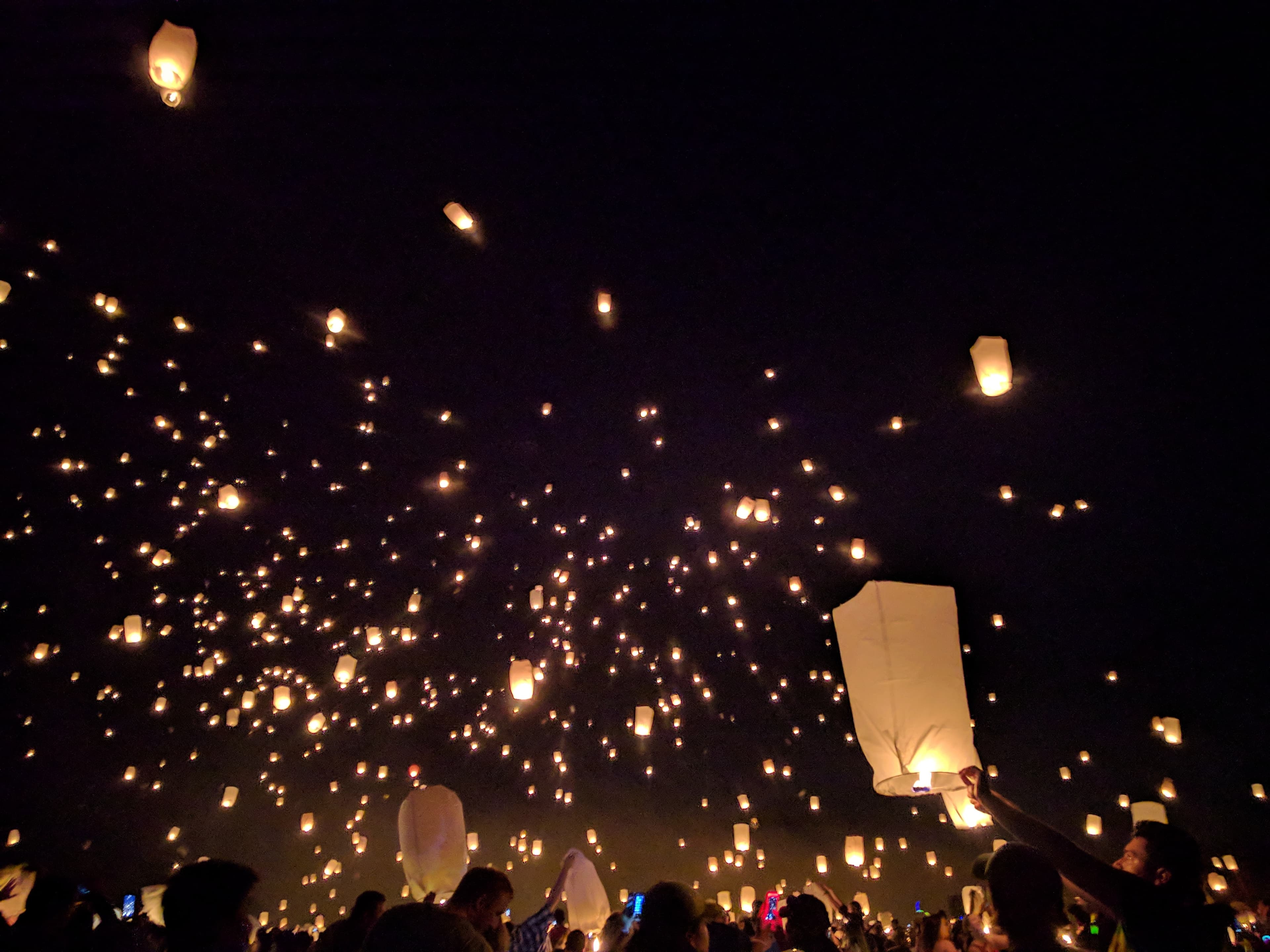 Lanterns rising into the night sky